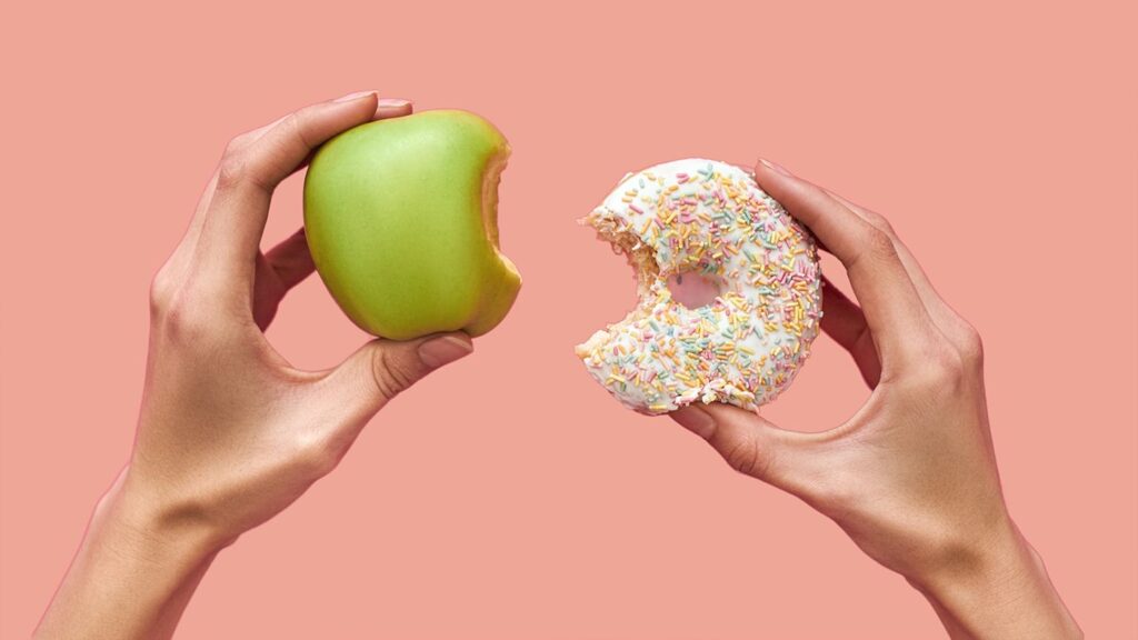 an apple and donut that a bite has been taken out of